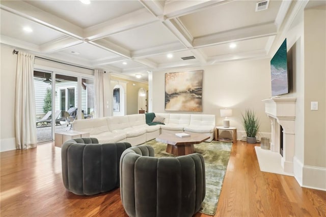 living room featuring coffered ceiling, beam ceiling, and light hardwood / wood-style flooring