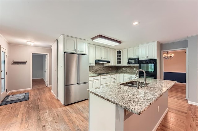 245 Sutallee Ridge Ln NE, White, GA 30184 - kitchen with black appliances, a sink, ornamental molding, a chandelier, and baseboards