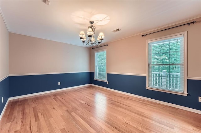 245 Sutallee Ridge Ln NE, White, GA 30184 - empty room featuring a chandelier, wood finished floors, ornamental molding, and baseboards