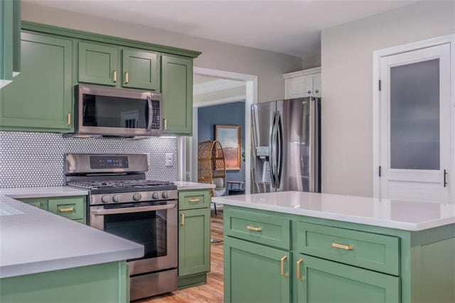 kitchen with green cabinets, light countertops, stainless steel appliances, and light wood-type flooring