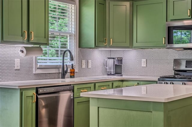 kitchen with light countertops, green cabinetry, stainless steel appliances, and tasteful backsplash