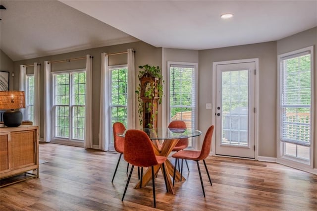 dining room with wood finished floors, baseboards, and recessed lighting