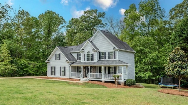 view of front of house featuring a trampoline, a porch, and a front yard