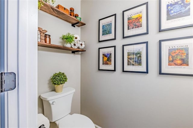 bathroom with toilet and baseboards