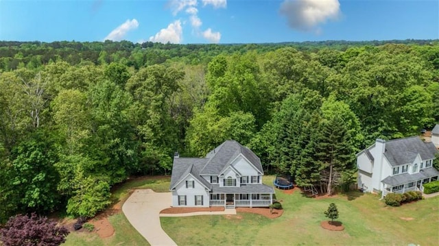 drone / aerial view featuring a wooded view