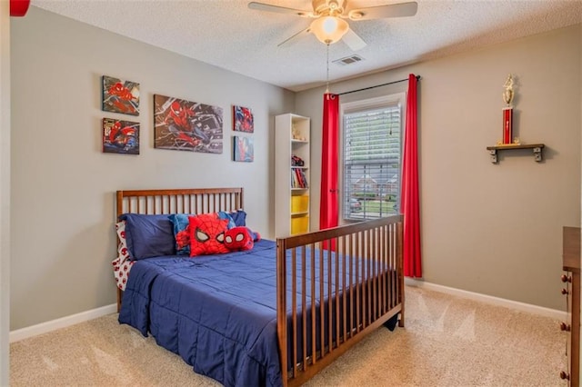 bedroom featuring baseboards, carpet flooring, visible vents, and a textured ceiling