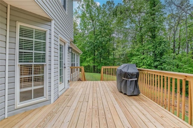 wooden deck featuring a grill