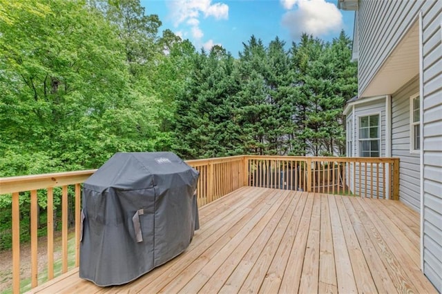 wooden deck featuring a grill