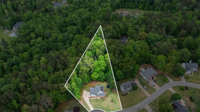 drone / aerial view with a wooded view