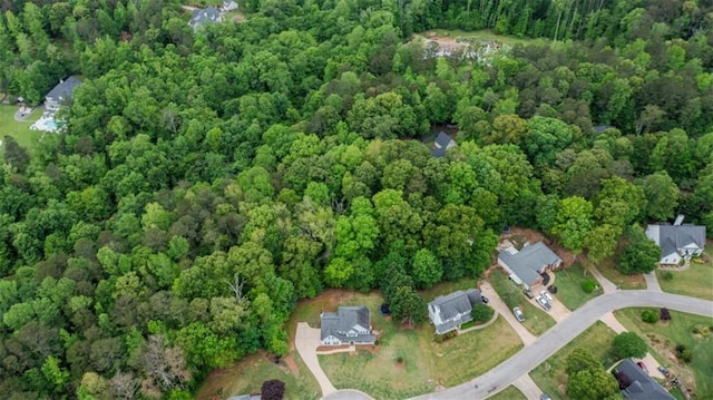 birds eye view of property with a view of trees