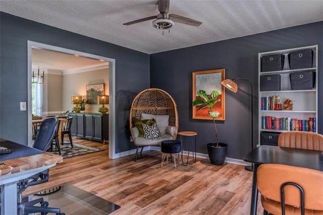 home office with ceiling fan, a textured ceiling, baseboards, and wood finished floors