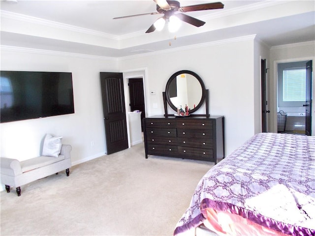 carpeted bedroom featuring ceiling fan, a raised ceiling, and crown molding