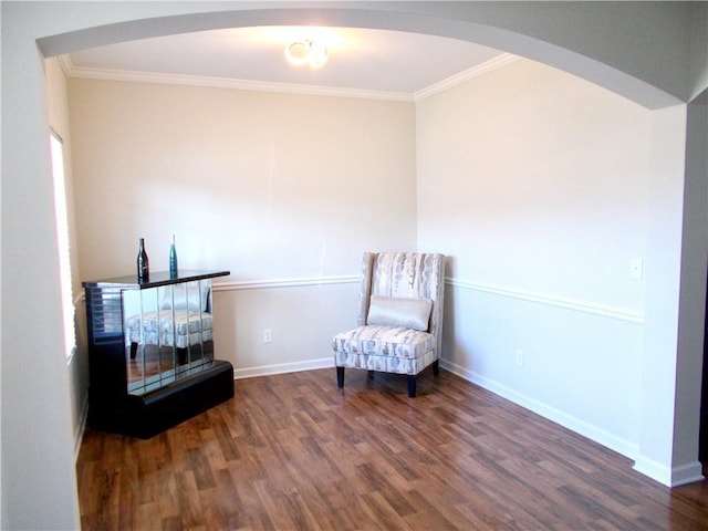 sitting room with dark hardwood / wood-style flooring and crown molding