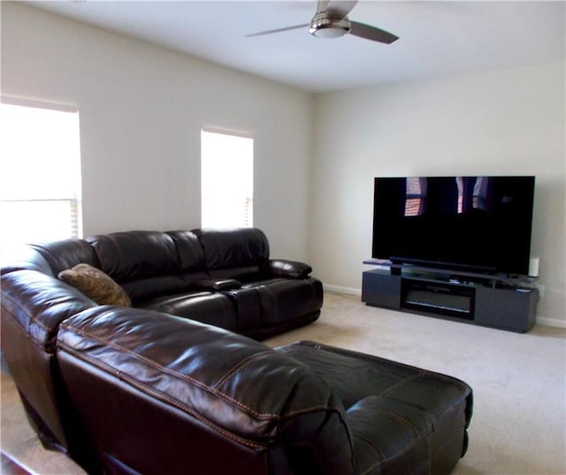 carpeted living room with ceiling fan and a wealth of natural light