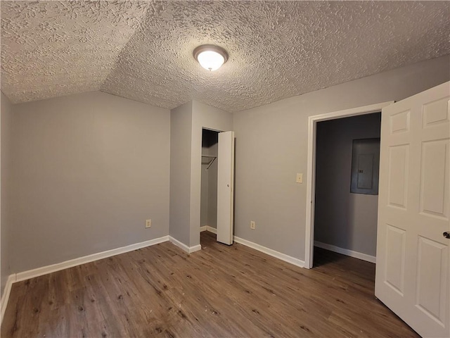 2940 Grand Ave SW, Atlanta, GA 30315 - unfurnished bedroom with a textured ceiling, a closet, electric panel, wood finished floors, and baseboards