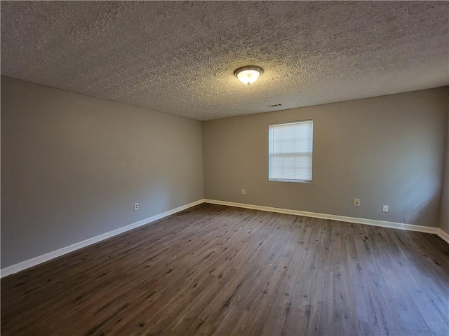 2940 Grand Ave SW, Atlanta, GA 30315 - spare room featuring a textured ceiling, baseboards, and dark wood finished floors