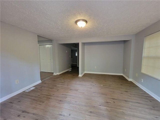 2940 Grand Ave SW, Atlanta, GA 30315 - empty room with visible vents, baseboards, wood finished floors, and a textured ceiling