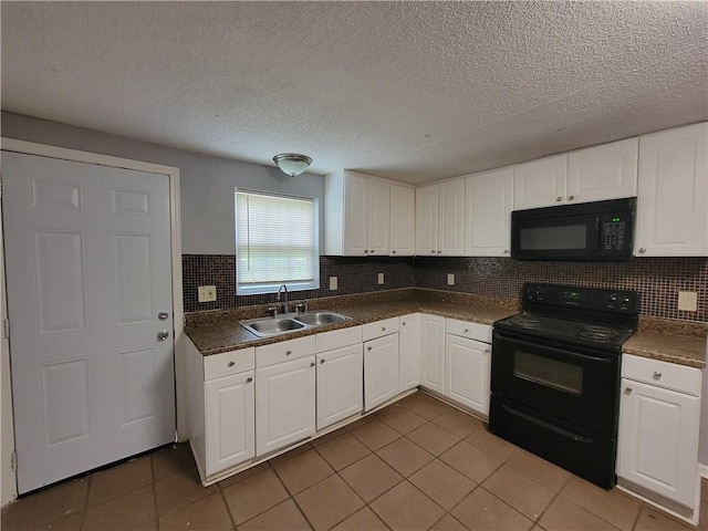 2940 Grand Ave SW, Atlanta, GA 30315 - kitchen featuring a sink, light tile patterned floors, black appliances, and white cabinetry
