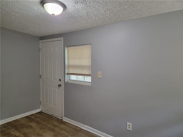 2940 Grand Ave SW, Atlanta, GA 30315 - interior space featuring a textured ceiling, dark wood-style flooring, and baseboards