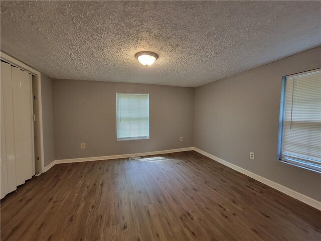 2940 Grand Ave SW, Atlanta, GA 30315 - unfurnished room with dark wood-style flooring, a textured ceiling, and baseboards