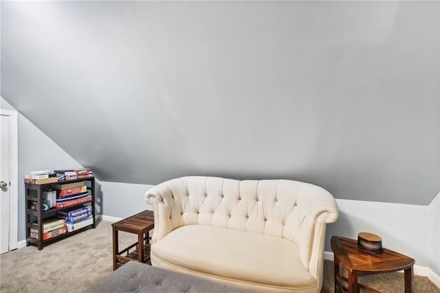 sitting room featuring carpet floors and lofted ceiling