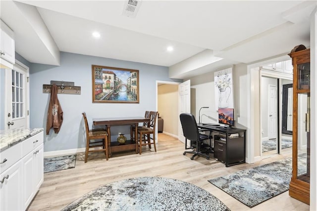 office area with light hardwood / wood-style floors