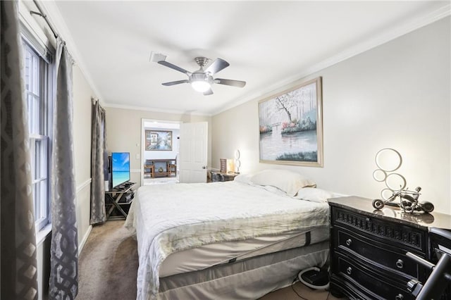 carpeted bedroom featuring multiple windows, ceiling fan, and ornamental molding