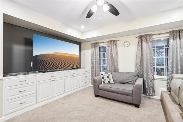 living room featuring light carpet and ceiling fan