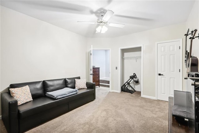 carpeted living room with ceiling fan