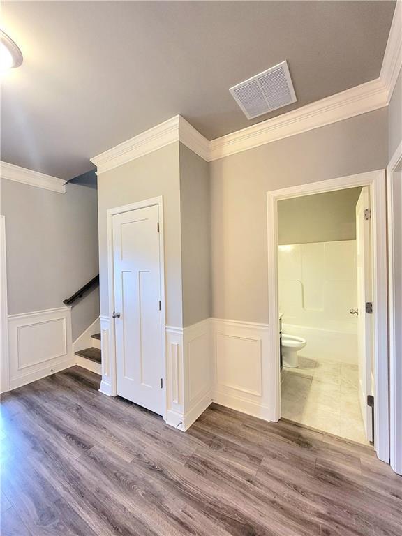 interior space with crown molding and hardwood / wood-style floors