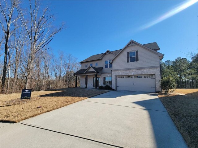 view of front of home with a garage and a front yard