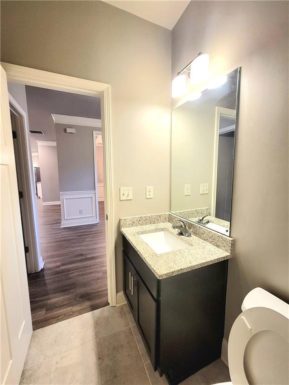 bathroom featuring toilet, vanity, and tile patterned flooring