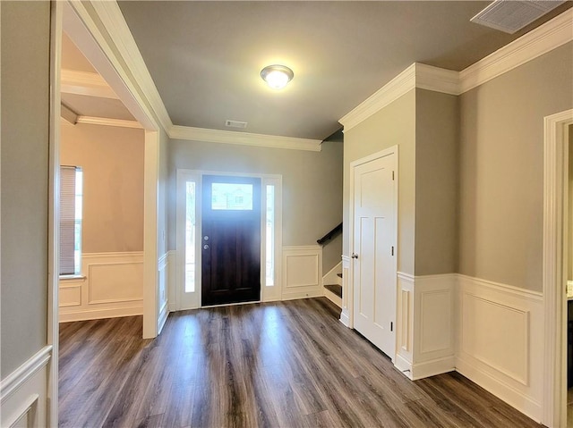 foyer with dark hardwood / wood-style floors and ornamental molding