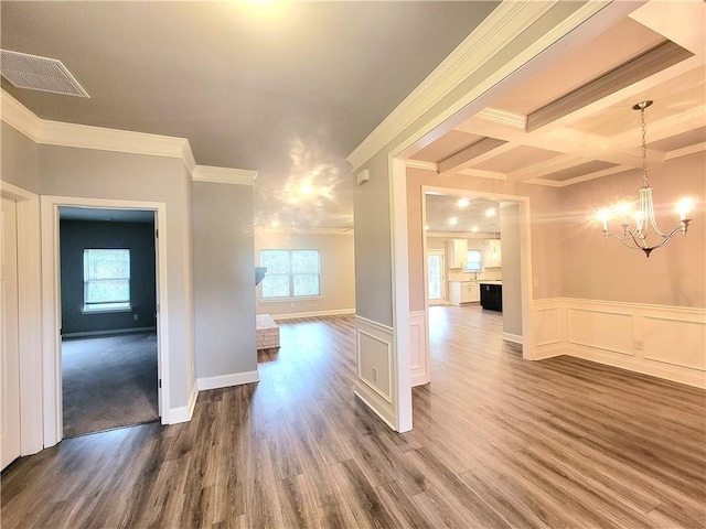 interior space with hardwood / wood-style flooring, a wealth of natural light, ornamental molding, and coffered ceiling