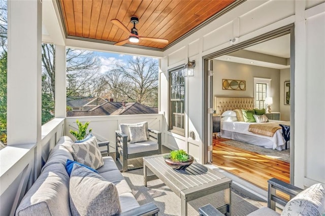 sunroom / solarium featuring wooden ceiling and ceiling fan