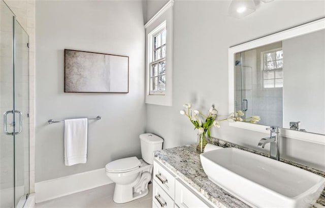 bathroom with a stall shower, tile patterned flooring, vanity, and toilet