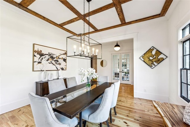 dining space with french doors, light wood-type flooring, coffered ceiling, and beam ceiling