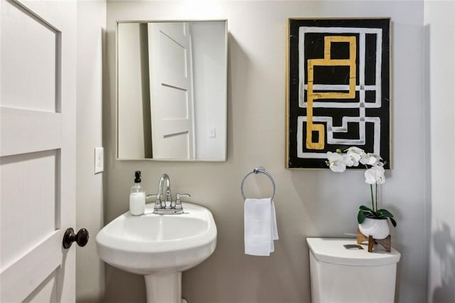 bathroom featuring toilet and a sink