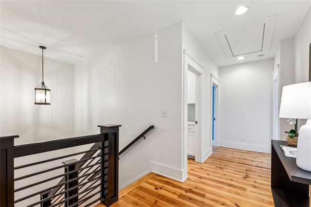 hall featuring recessed lighting, an upstairs landing, baseboards, light wood-style floors, and attic access