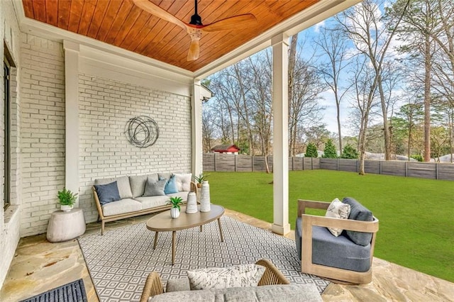 sunroom / solarium featuring a ceiling fan, wooden ceiling, and plenty of natural light