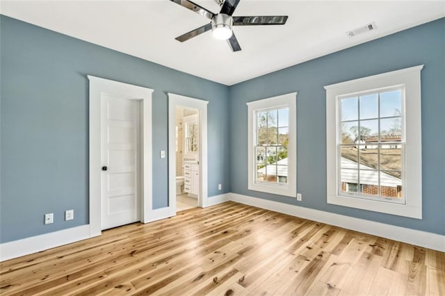 unfurnished bedroom featuring visible vents, baseboards, and wood finished floors