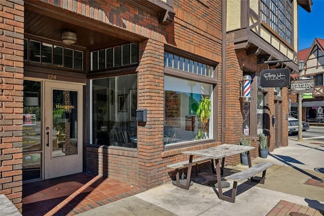 property entrance featuring brick siding