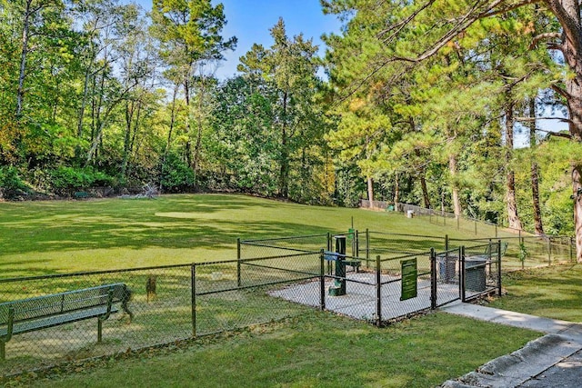 surrounding community with a gate, a lawn, and fence