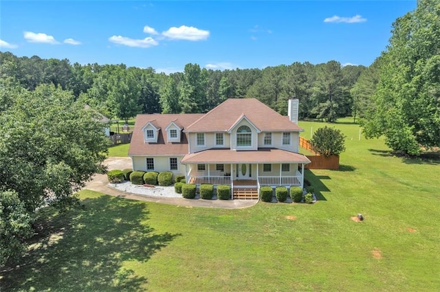 161 Honey Creek Rd, Mcdonough, GA 30252 - view of front of home featuring covered porch, a wooded view, a chimney, and a front yard