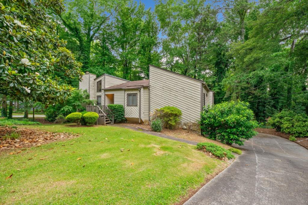 766 Lost Creek Cir, Stone Mountain, GA 30088 - view of front facade with a front lawn and driveway