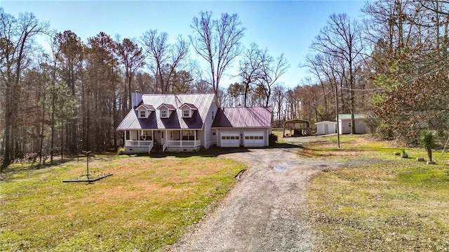 cape cod home featuring covered porch, metal roof, a garage, driveway, and a front lawn