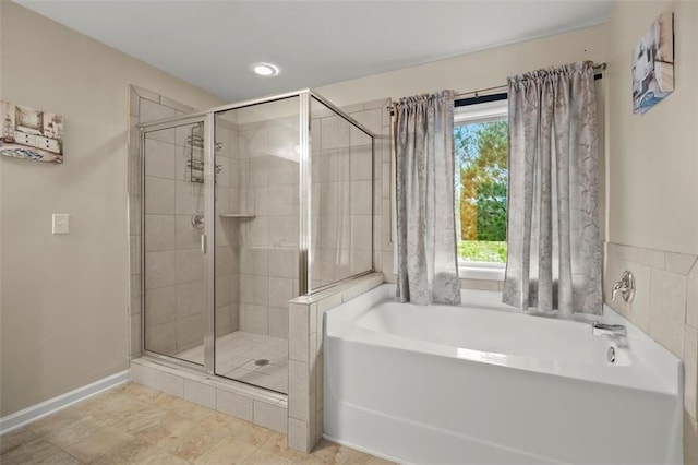 1709 Grove Ct SE, Conyers, GA 30013 - full bathroom with a shower stall, a garden tub, baseboards, and recessed lighting