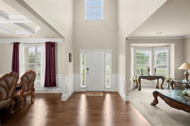 1709 Grove Ct SE, Conyers, GA 30013 - foyer entrance with healthy amount of natural light, wood-type flooring, ornamental molding, a wainscoted wall, and beam ceiling