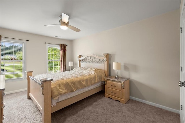 1709 Grove Ct SE, Conyers, GA 30013 - bedroom featuring baseboards, light carpet, and ceiling fan