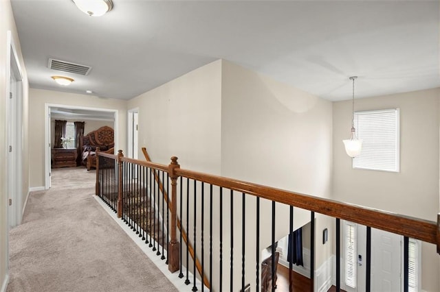 1709 Grove Ct SE, Conyers, GA 30013 - corridor featuring an upstairs landing, healthy amount of natural light, carpet flooring, and baseboards